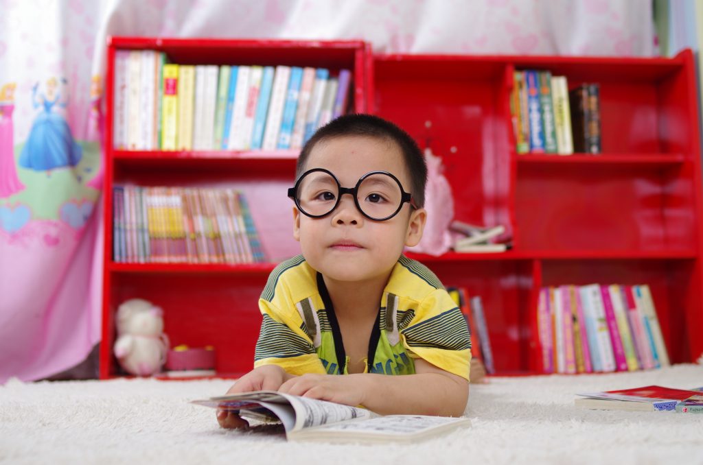 Polymathic: boy by bookshelf