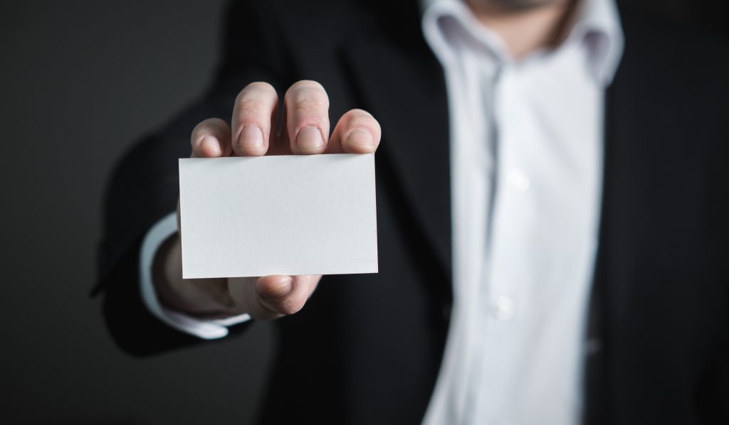 Here's How To Determine The Perfect Career For You - man holding blank business card