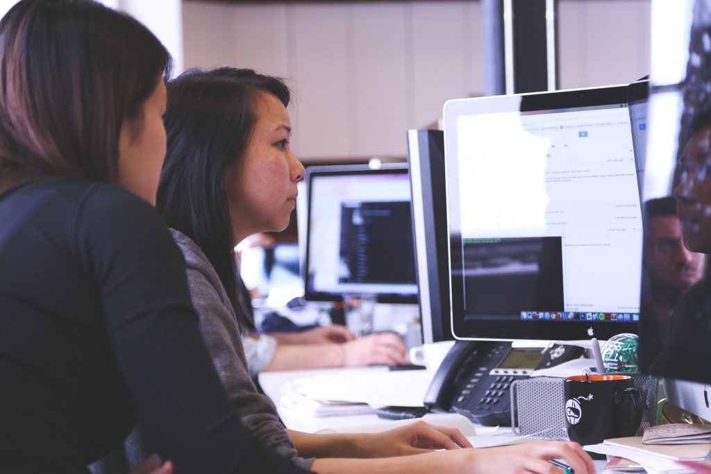 practicing mindfulness - two women deeply interested in work